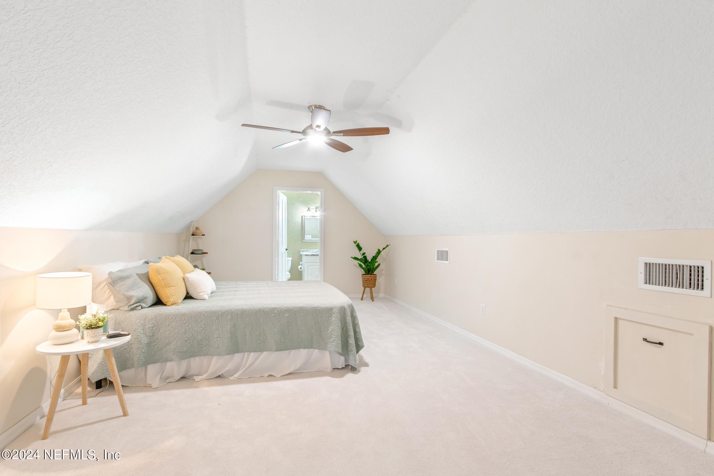 205 Shirley's Way St. Augustine, FL 32086 - Photo 28 of 57 a bedroom with a bed and a chandelier