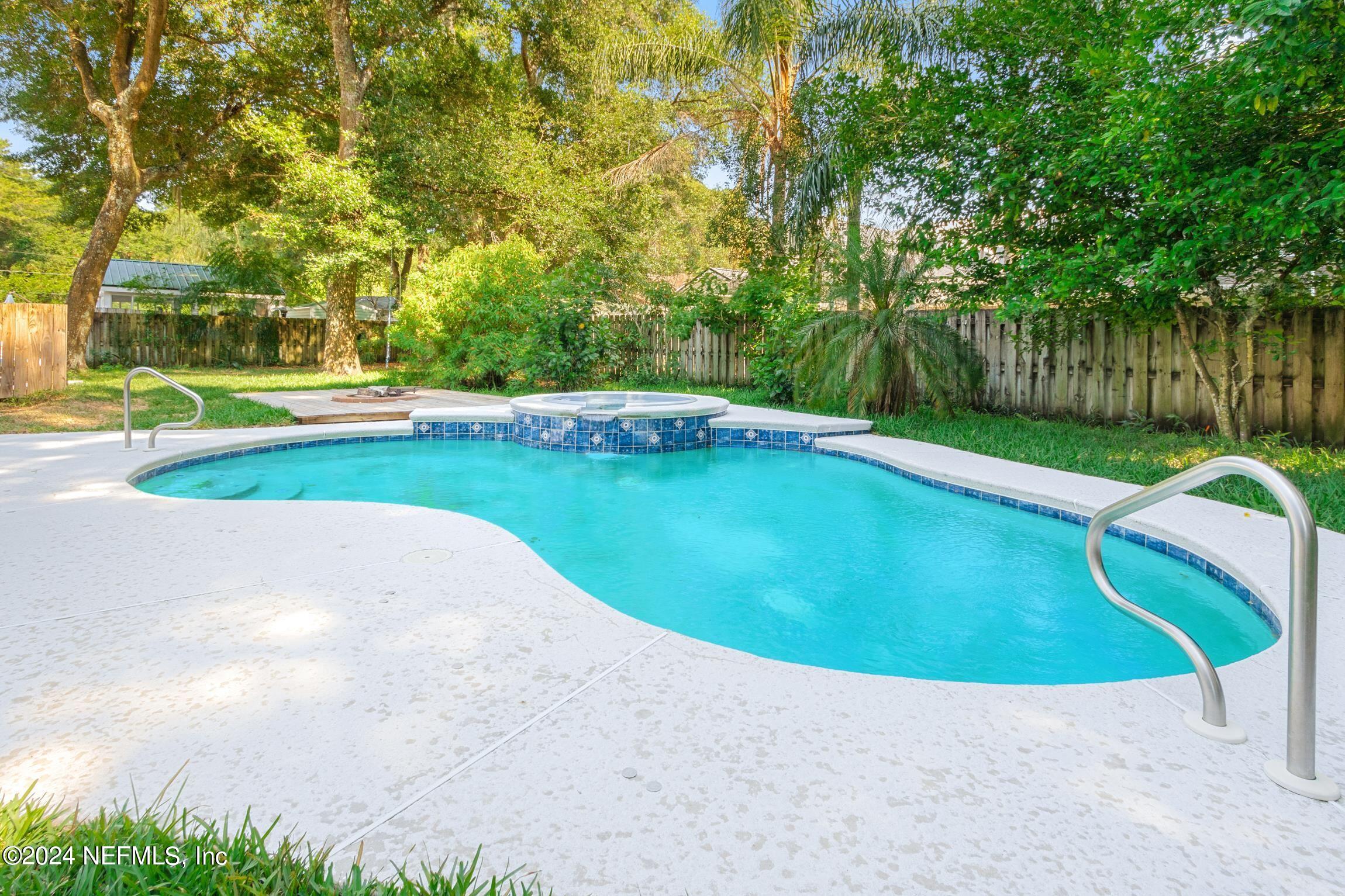 205 Shirley's Way St. Augustine, FL 32086 - Photo 32 of 57 a view of a swimming pool and trees in the background