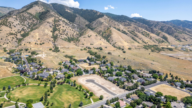 1473 Red Fox Court, Unit 4 Logan, UT 84321 - Photo 3 of 19 Aerial perspective showcasing a residential community with established homes, green spaces, and undeveloped lots