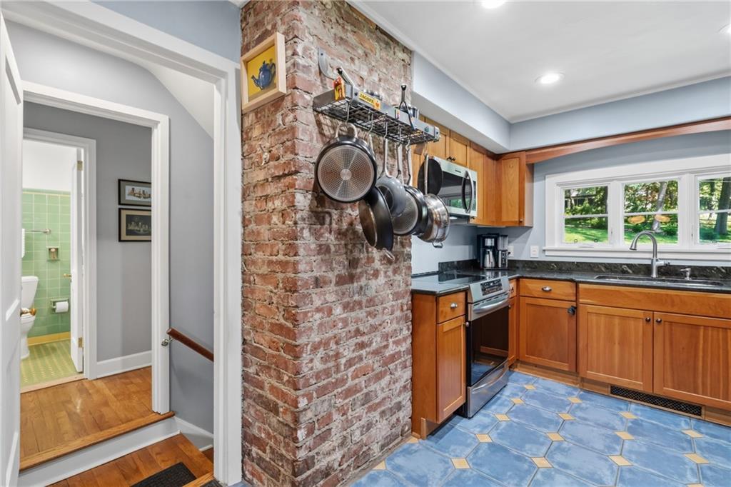119 Byron Road Pittsburgh, PA 15237 - Photo 12 of 36 Brick accent wall incorporates handy hanging rack for your pots and pans.