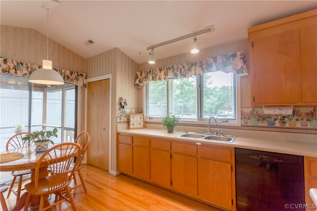 14338 Regatta Pointe Road Midlothian, VA 23112 - Photo 15 of 40 a kitchen with a sink and wooden cabinets