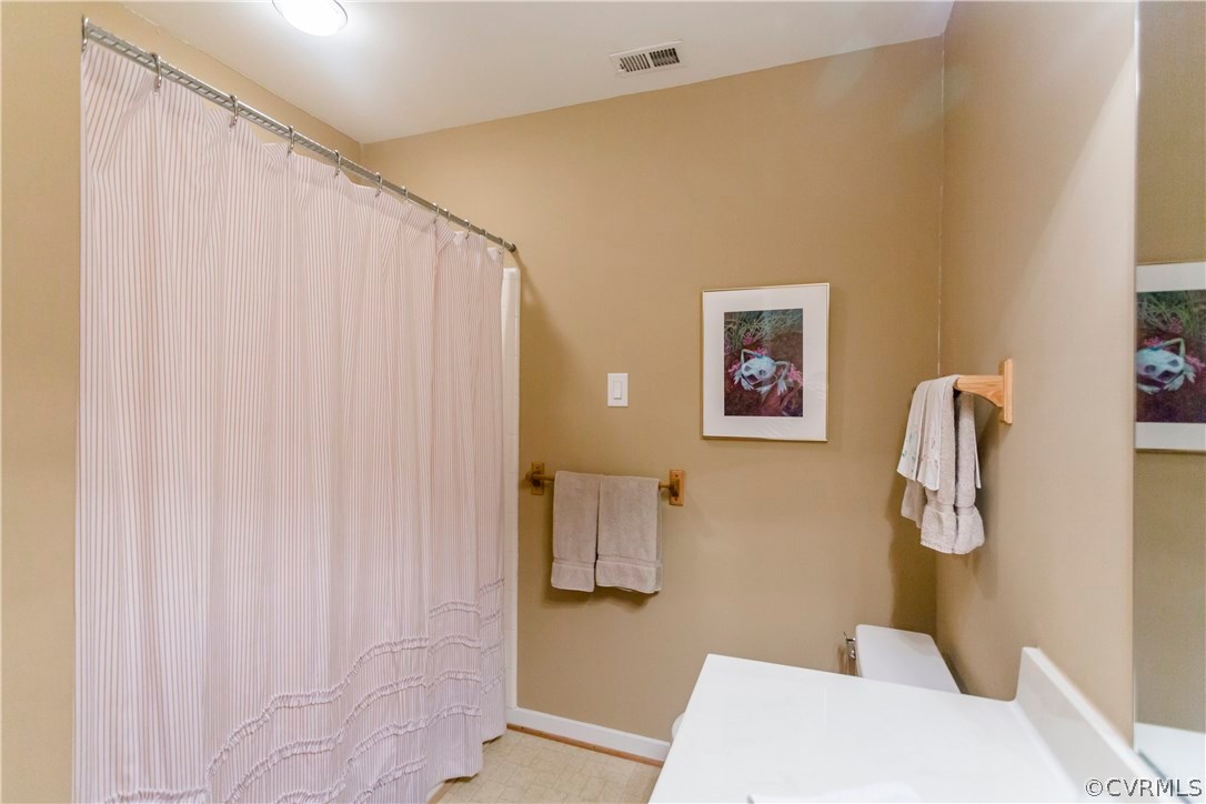 14338 Regatta Pointe Road Midlothian, VA 23112 - Photo 26 of 40 a bathroom with a shower curtain and a sink