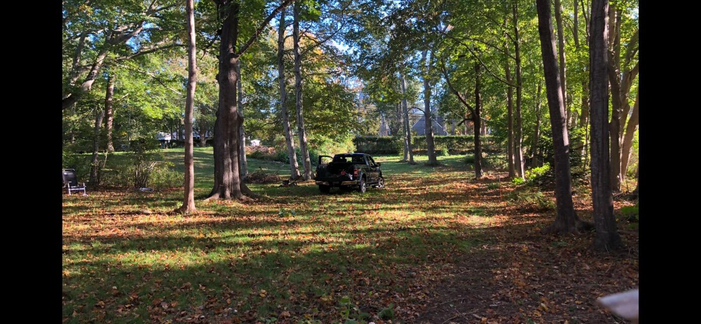 3850 Main Street Barnstable, MA 02630 - Photo 12 of 16 a backyard of a house with table and chairs