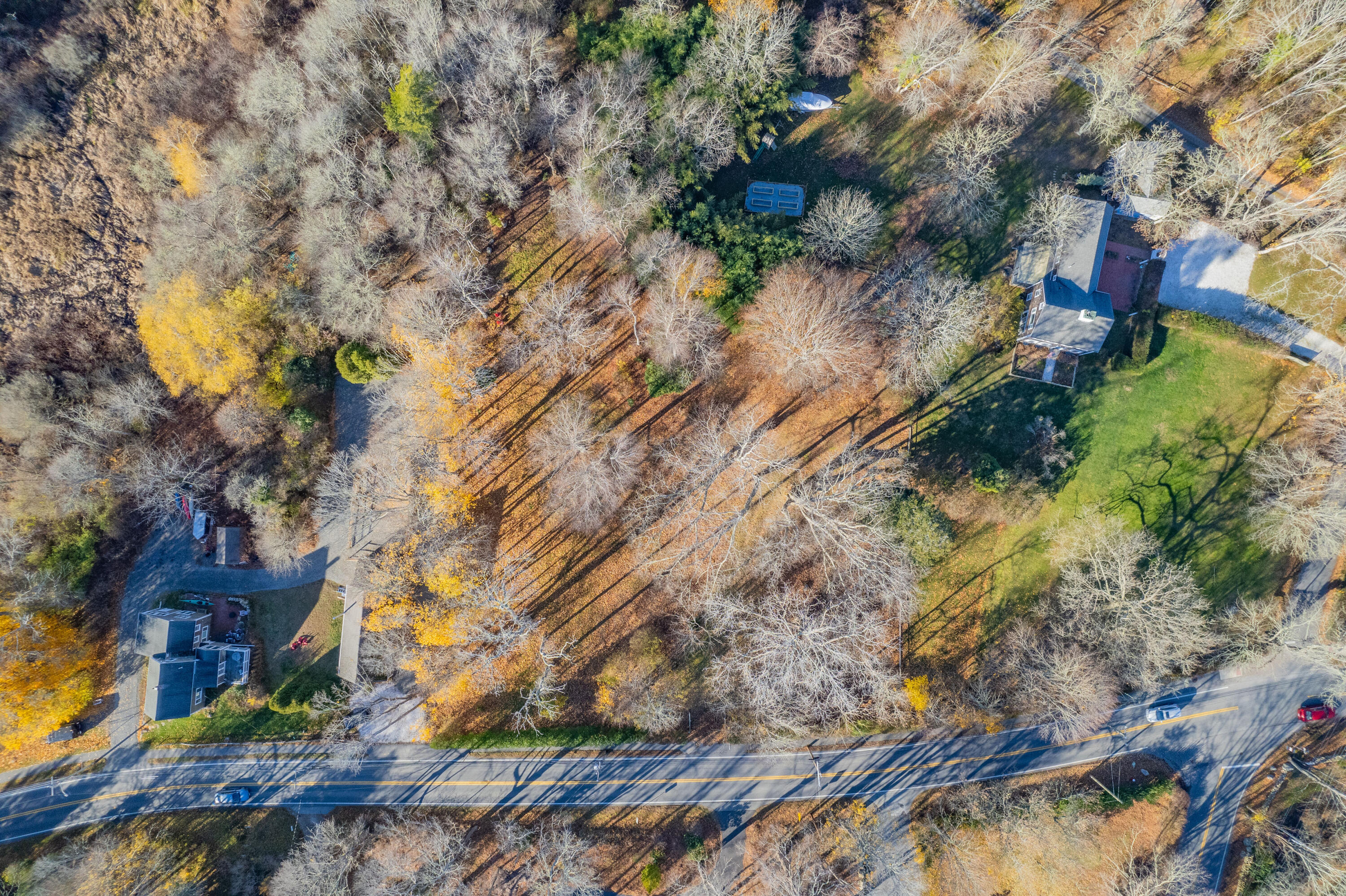 3850 Main Street Barnstable, MA 02630 - Photo 14 of 16 a backyard of a building and trees all around