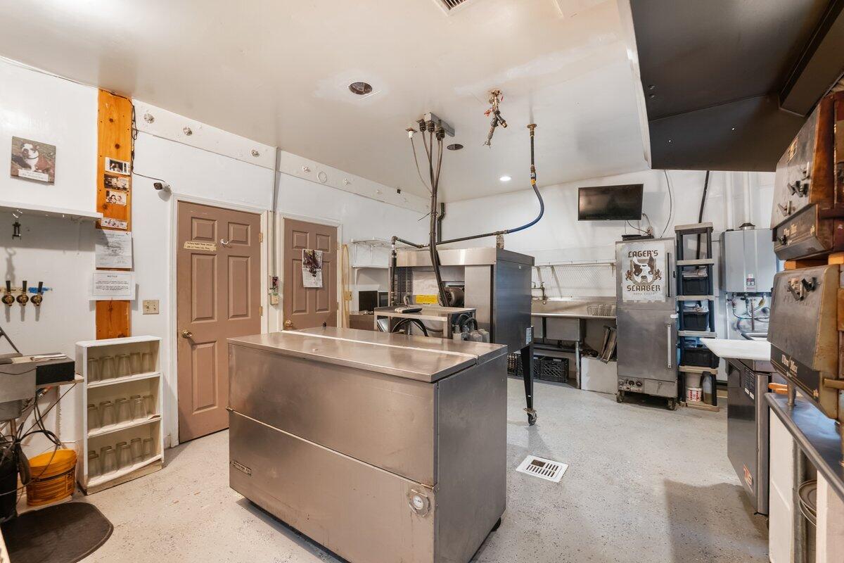 110 Squaw Valley Road McCloud, CA 96057 - Photo 10 of 20 a kitchen with cabinets and chairs