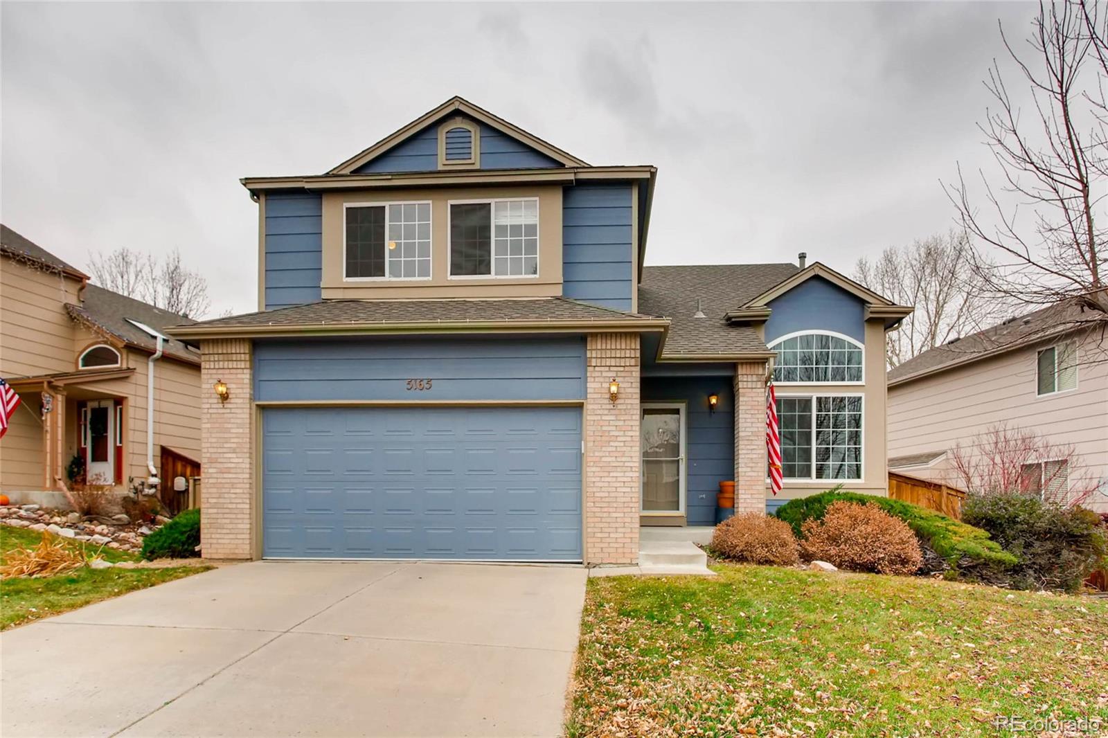 5165 Weeping Willow Circle Highlands Ranch, CO 80130 - Photo 1 of 28 a front view of a house with a yard and garage