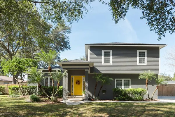 a view of a house with backyard and swimming pool