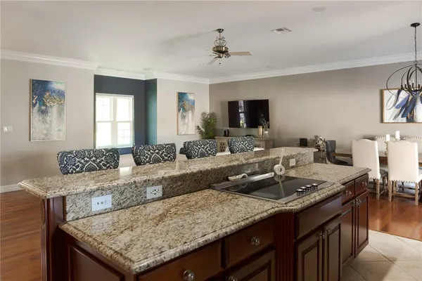 a living room with granite countertop furniture and a flat screen tv