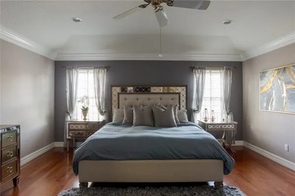 a bedroom with a large bed and a tv