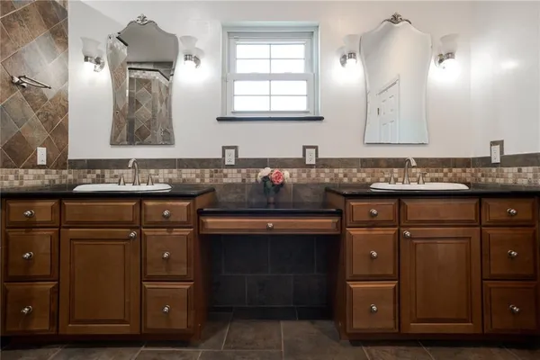 a kitchen with granite countertop a sink and cabinets