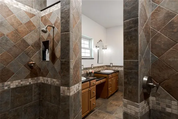 a bathroom with a shower and a sink
