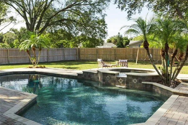 a view of a swimming pool with a lounge chairs
