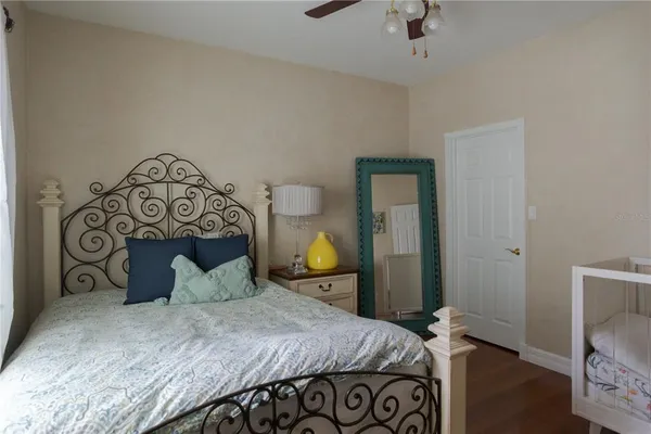 a bedroom with a bed and a lamp on table