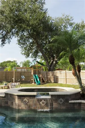 a view of swimming pool with outdoor seating and yard