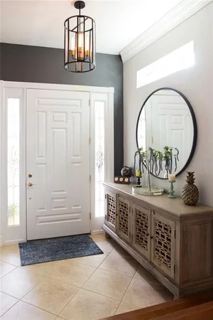 a view of entryway with granite countertop and a sink