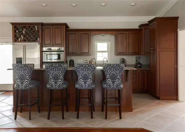 a view of kitchen with dining area cabinets and refrigerator