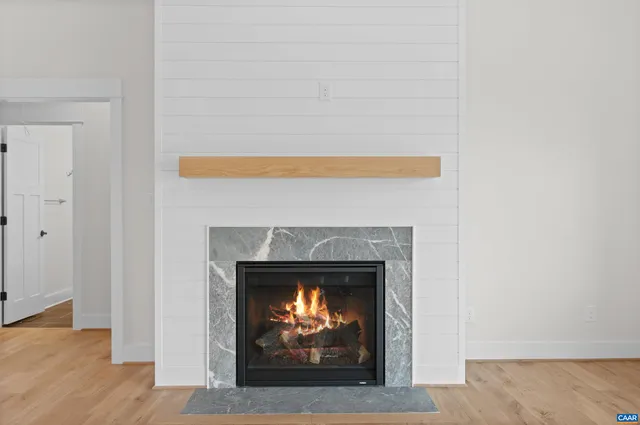 a large kitchen with stainless steel appliances granite countertop a sink dishwasher a stove and a refrigerator with wooden floor