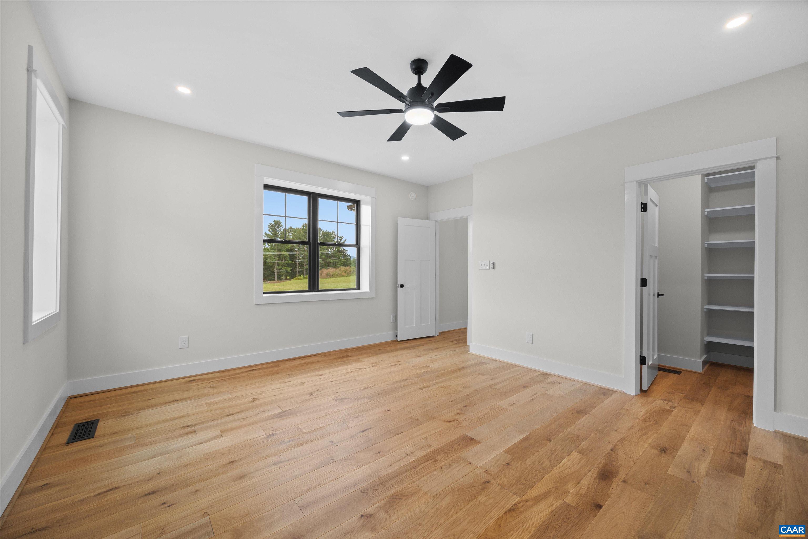 1416 Ladd Road Waynesboro, VA 22980 - Photo 25 of 66 a view of a big room with wooden floor a ceiling fan and windows