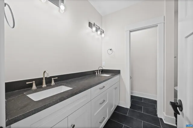 a view of a room with wooden floor and a ceiling fan