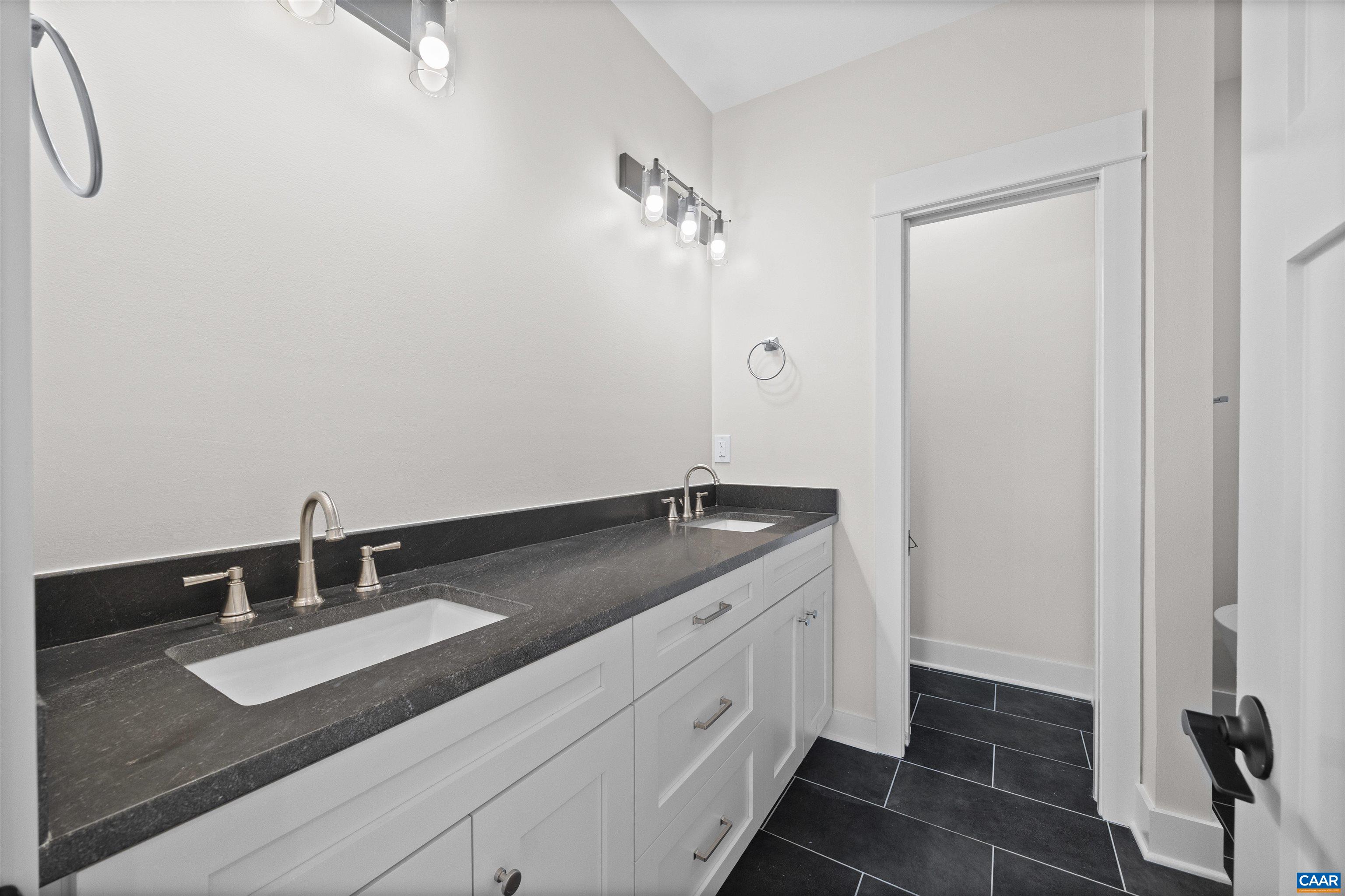 1416 Ladd Road Waynesboro, VA 22980 - Photo 27 of 66 a bathroom with a granite countertop sink and a mirror