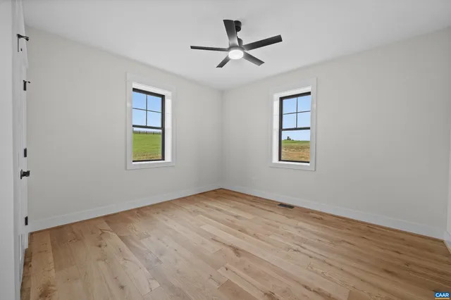 a view of a kitchen with refrigerator and windows