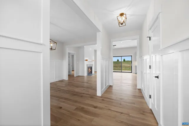 a view of a room with wooden floor and chandelier
