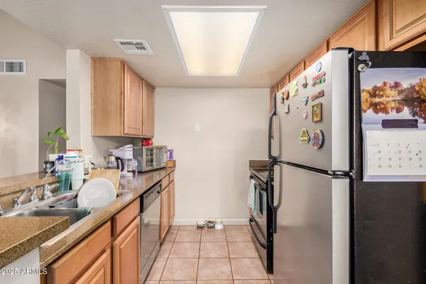 a kitchen with stainless steel appliances granite countertop a refrigerator and a sink