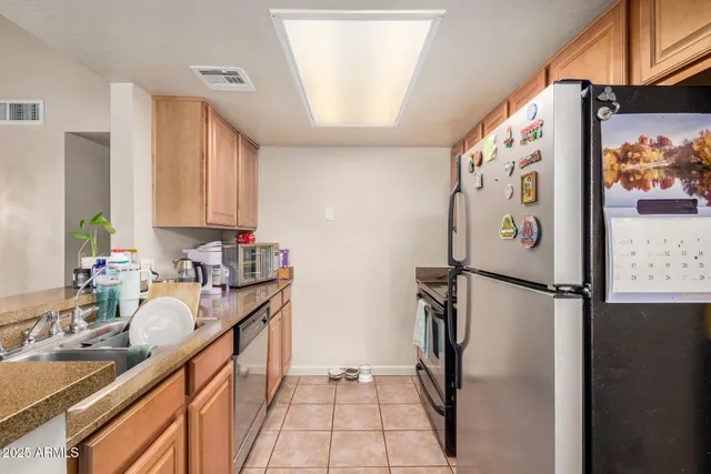 a kitchen with stainless steel appliances granite countertop a refrigerator and a sink