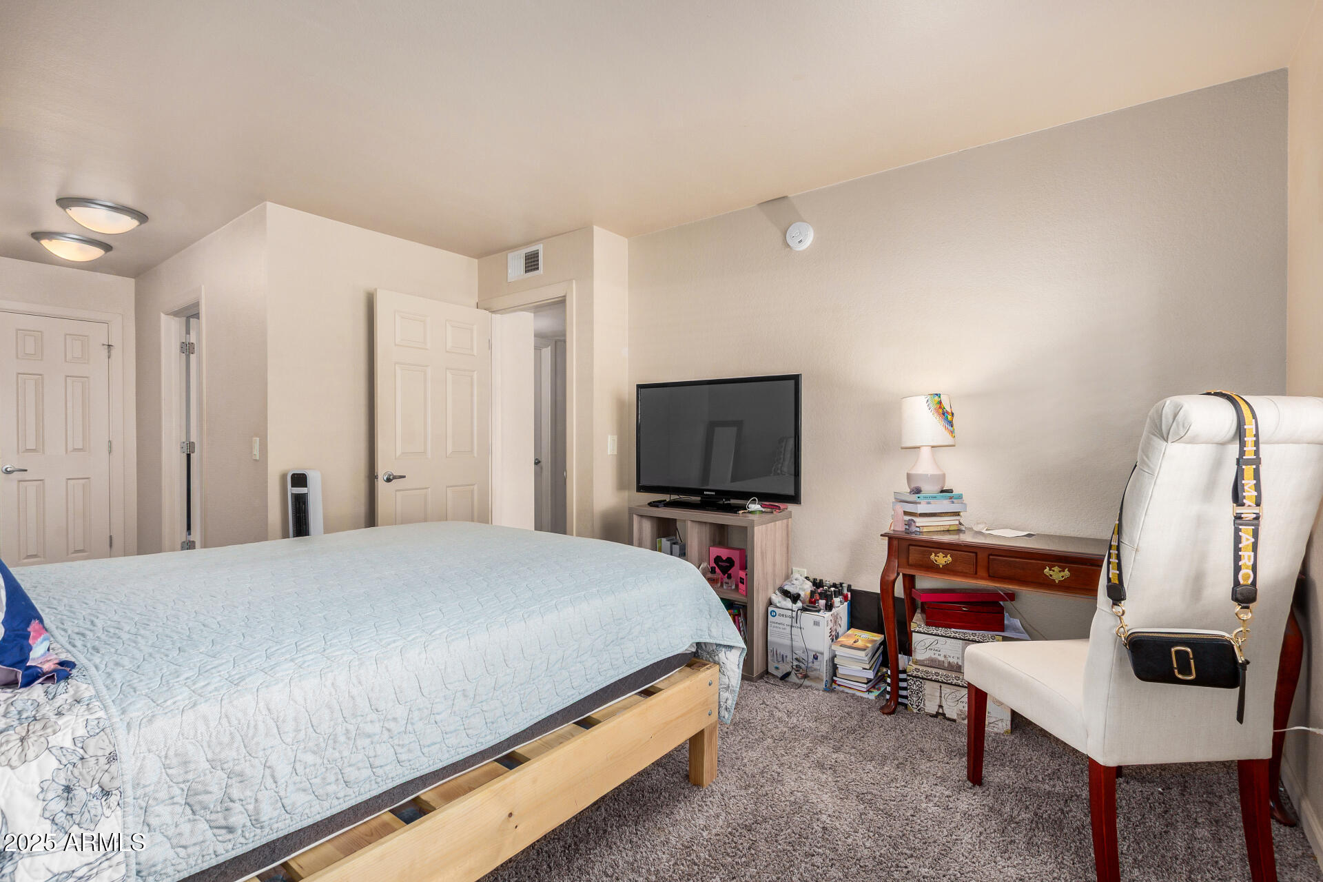 101 South Players Club Drive, Unit 22201 Tucson, AZ 85745 - Photo 17 of 31 a bedroom with a bed and a flat screen tv