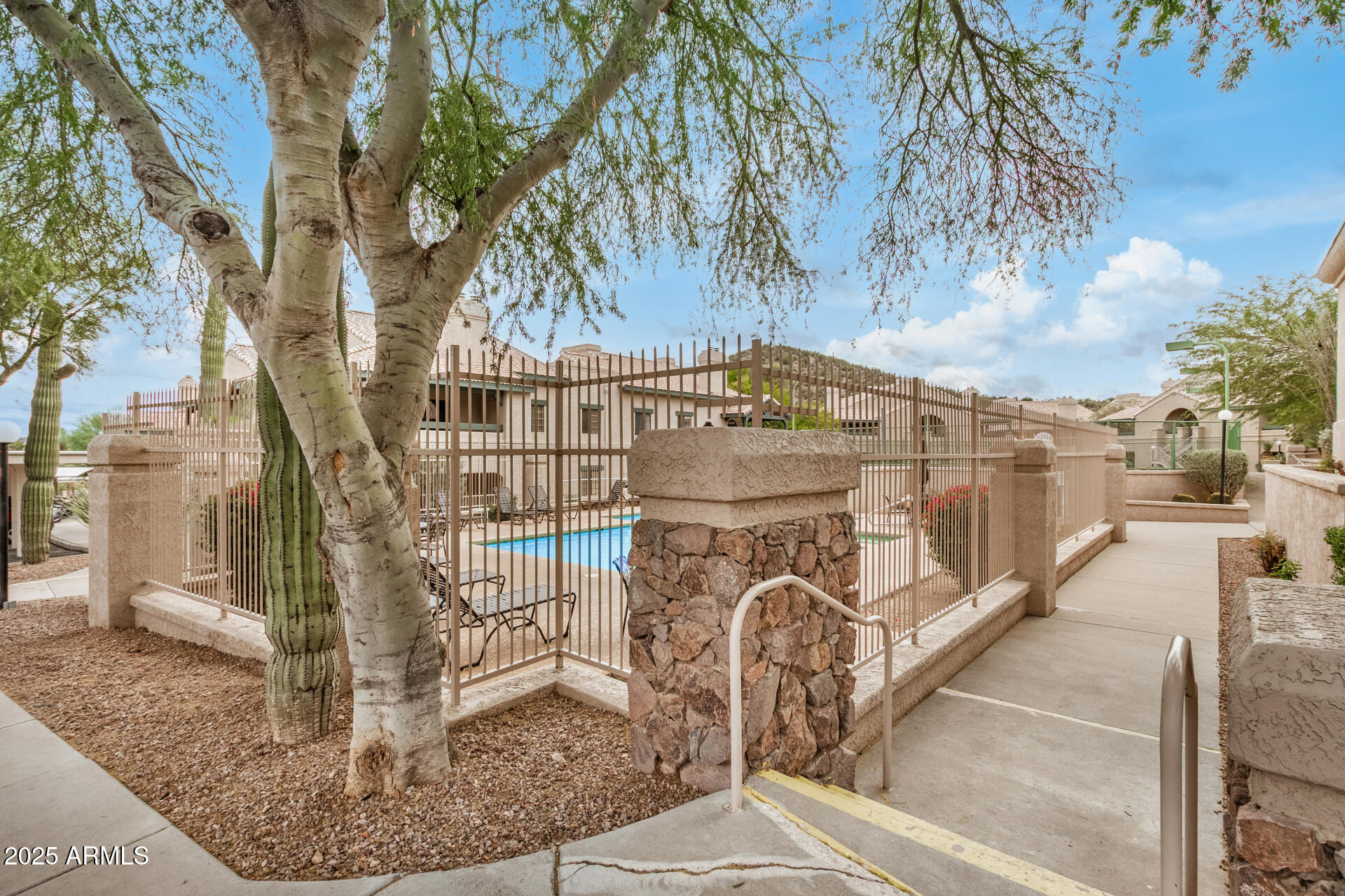 101 South Players Club Drive, Unit 22201 Tucson, AZ 85745 - Photo 27 of 31 a view of a swimming pool with a patio