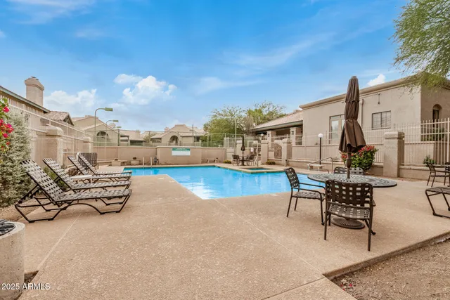 a view of swimming pool with outdoor seating and city view