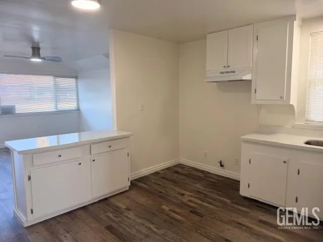 a view of a kitchen with wooden floor