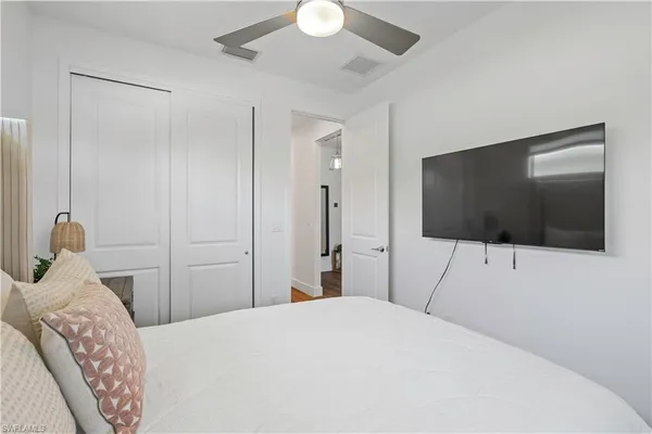 a bedroom with a bed and a flat screen tv