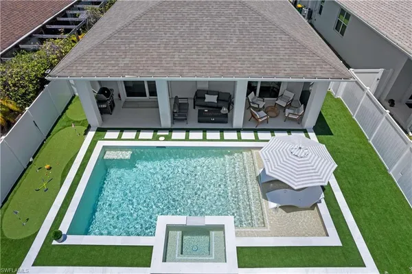 an aerial view of a house with a yard table and chairs