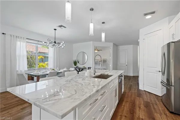 a kitchen with center island and stainless steel appliances