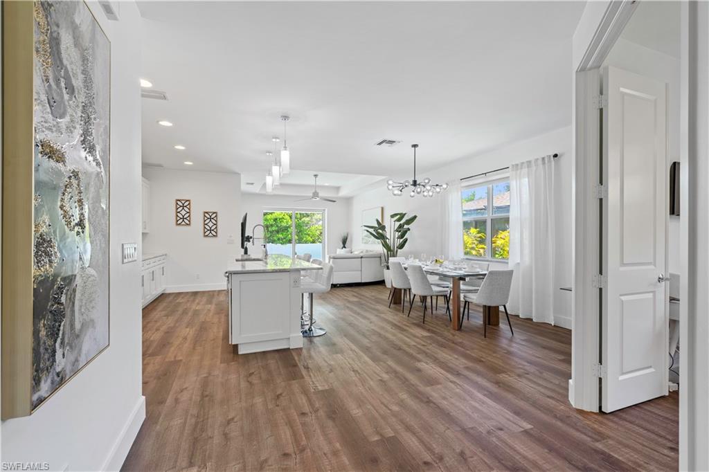 1100 Steeves Avenue Naples, FL 34104 - Photo 36 of 38 a view of a dining room with furniture and wooden floor