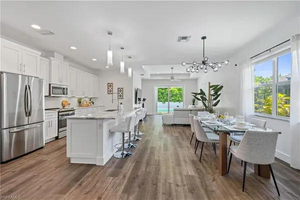 a bathroom with a granite countertop double vanity sink and a mirror