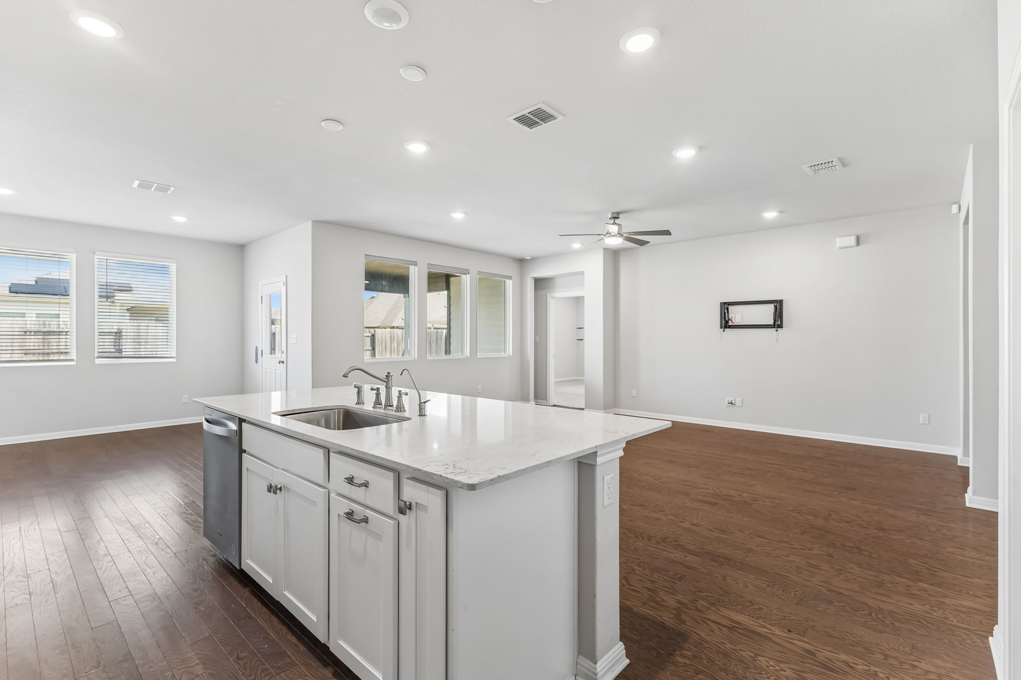 4009 Milano River Road Hutto, TX 78634 - Photo 11 of 40 Rich hardwood floors contrast beautifully with clean white walls and stone counters.