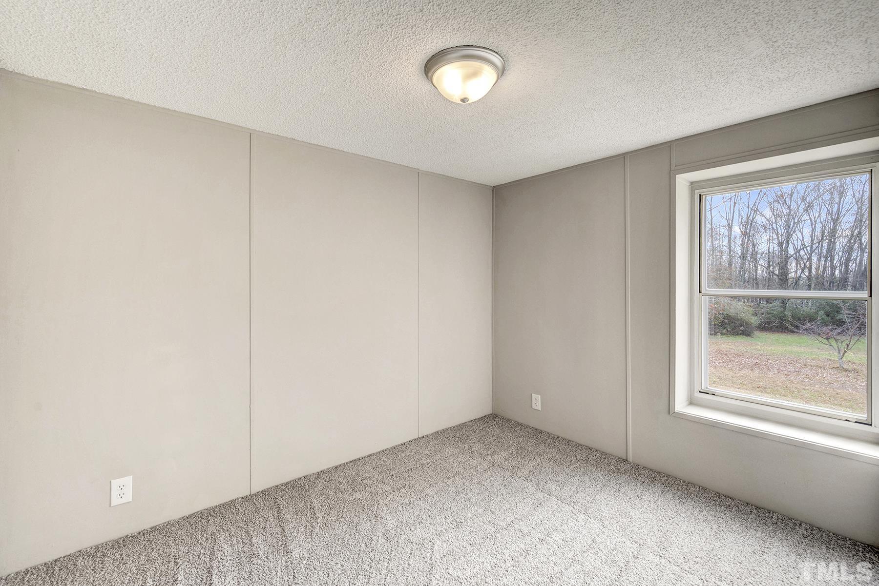 4920 Zacks Mill Road Angier, NC 27501 - Photo 19 of 30 an empty room with windows