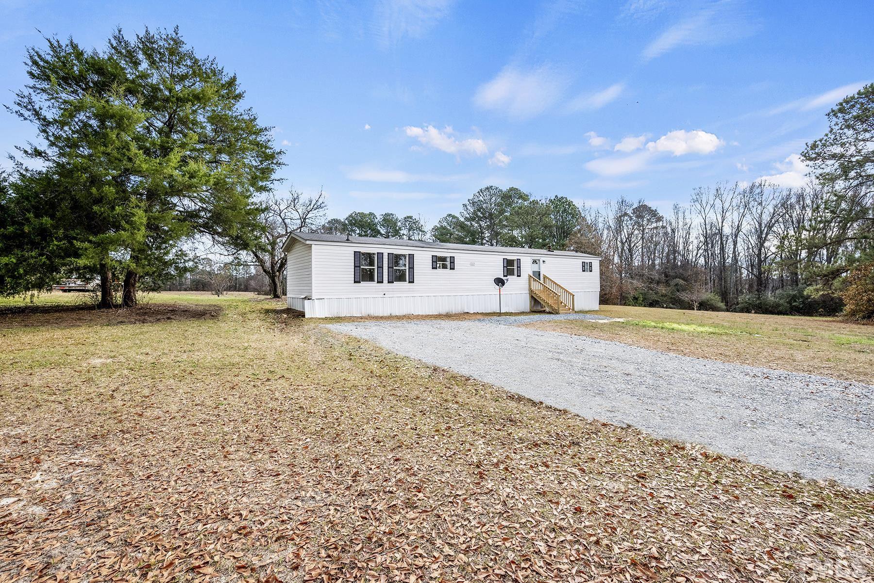 4920 Zacks Mill Road Angier, NC 27501 - Photo 2 of 30 a view of house with yard and trees in the background