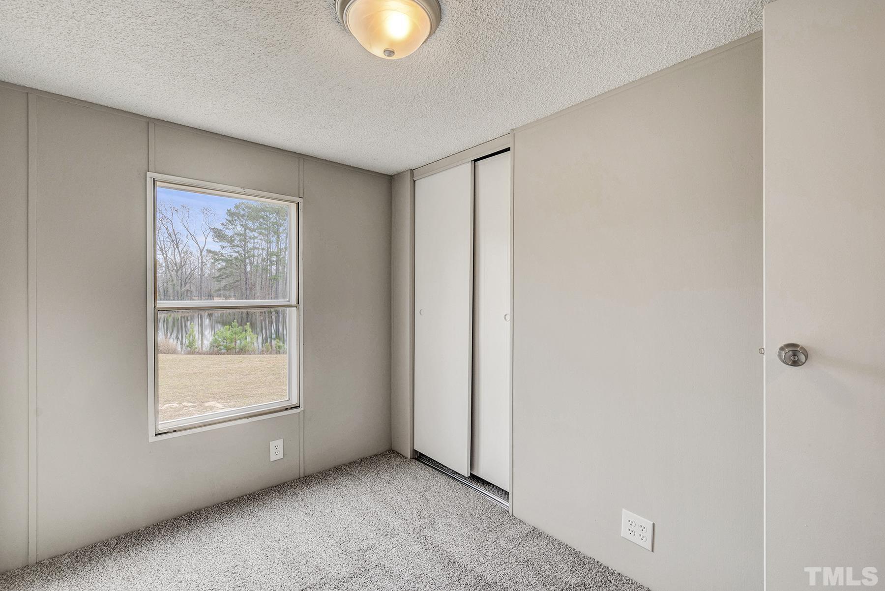 4920 Zacks Mill Road Angier, NC 27501 - Photo 22 of 30 a view of an empty room with a window