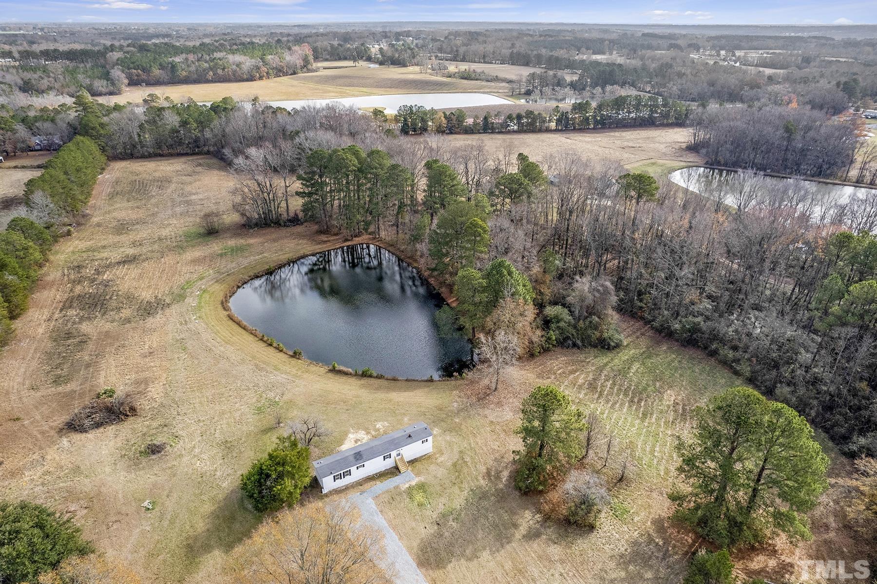 4920 Zacks Mill Road Angier, NC 27501 - Photo 24 of 30 a view of a lake with a yard