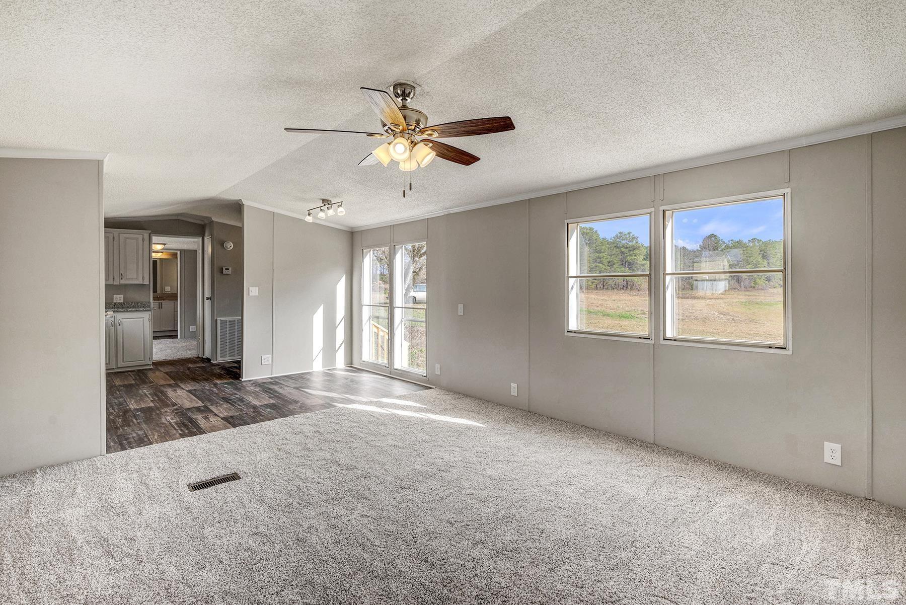 4920 Zacks Mill Road Angier, NC 27501 - Photo 7 of 30 a view of a livingroom with a ceiling fan and window