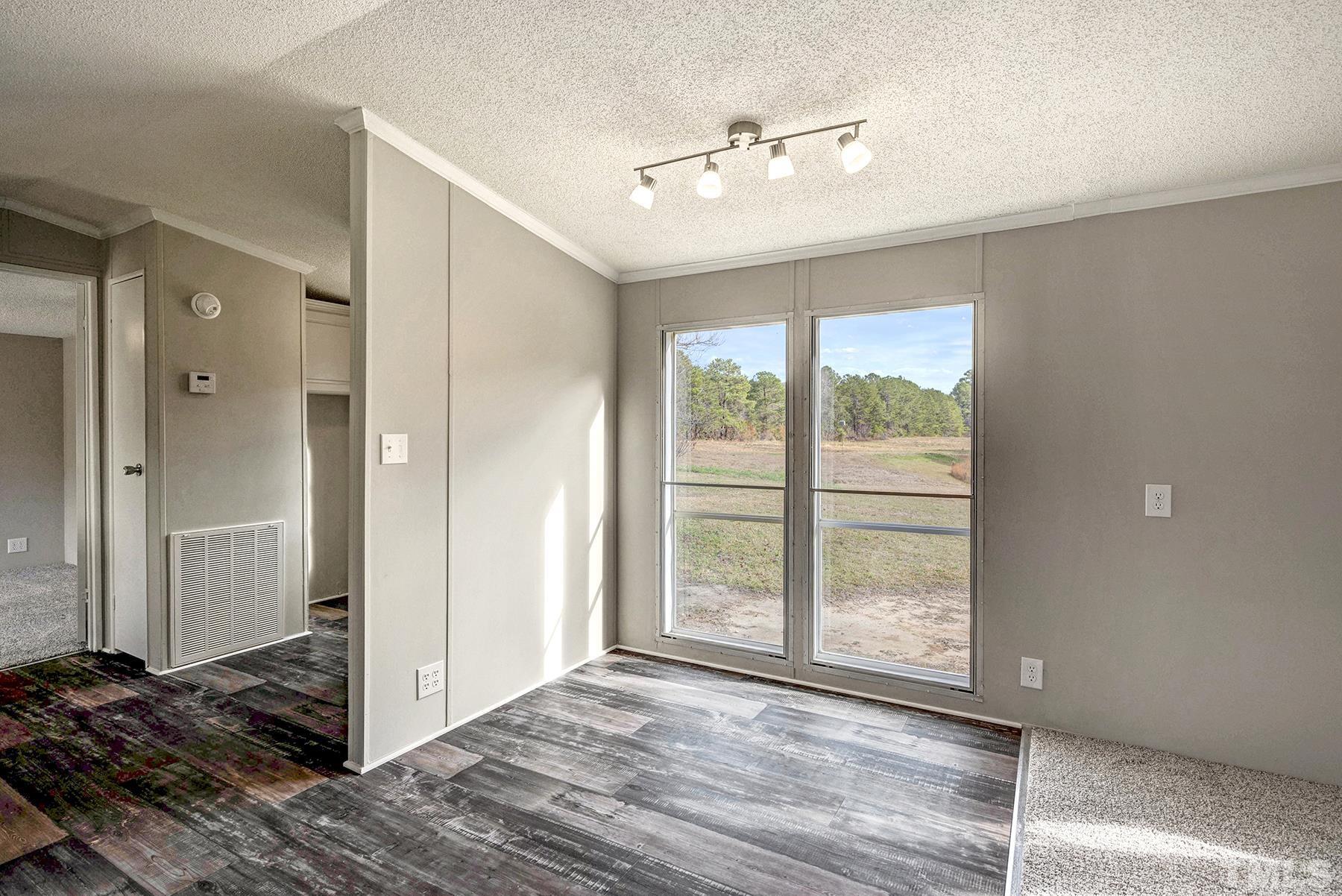 4920 Zacks Mill Road Angier, NC 27501 - Photo 9 of 30 a view of a livingroom with wooden floor and a window