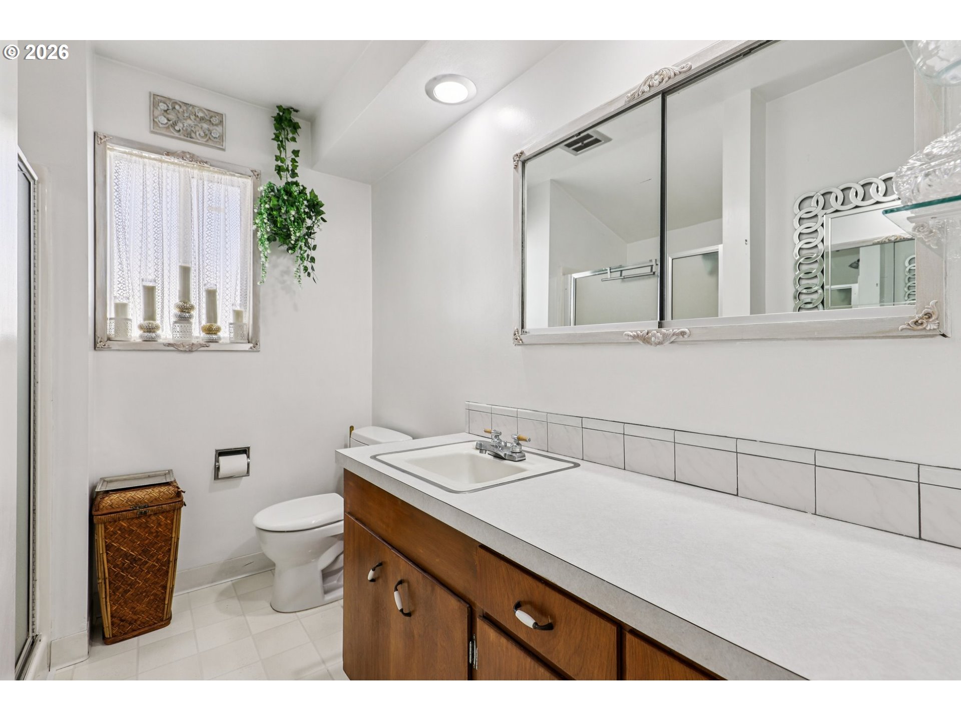 801 Cowlitz Way Kelso, WA 98626 - Photo 24 of 36 a bathroom with a granite countertop toilet sink and mirror