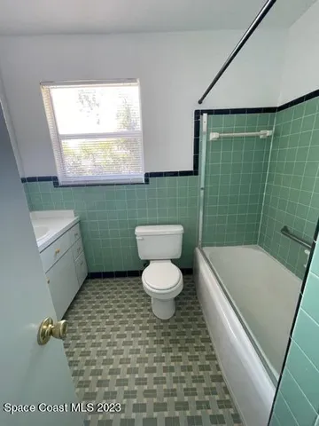 a bathroom with a toilet a sink and bathtub
