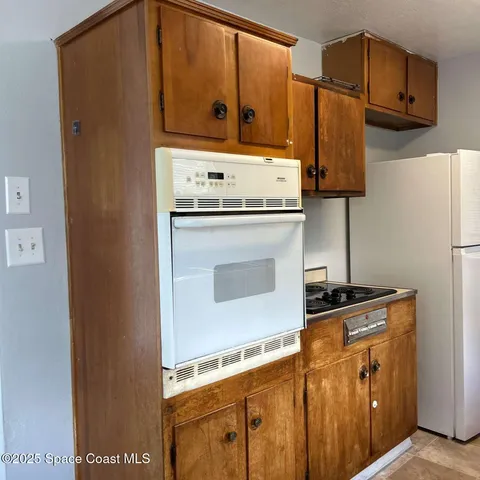 a kitchen with stainless steel appliances granite countertop a refrigerator and a stove