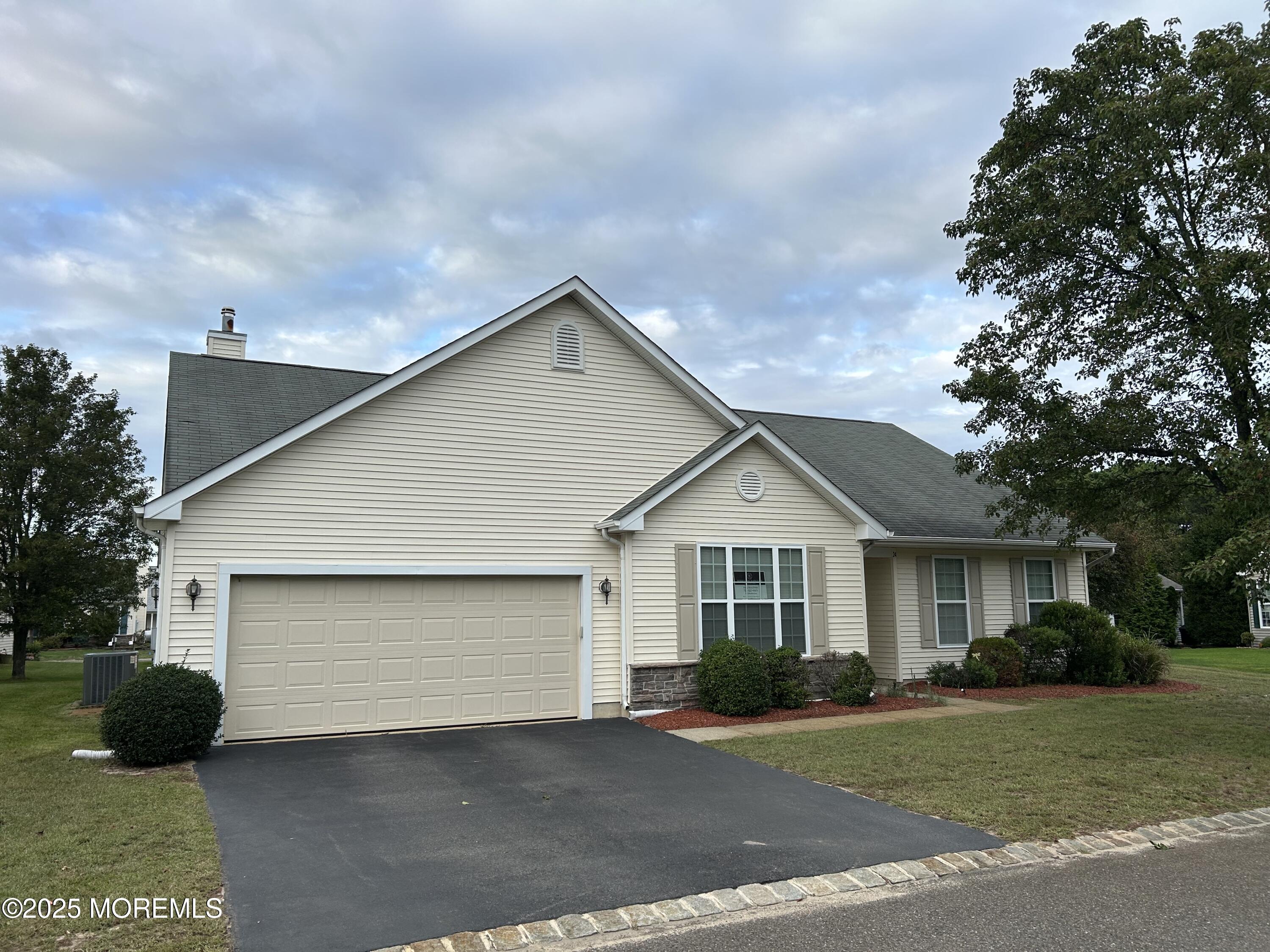 a front view of a house with a garden