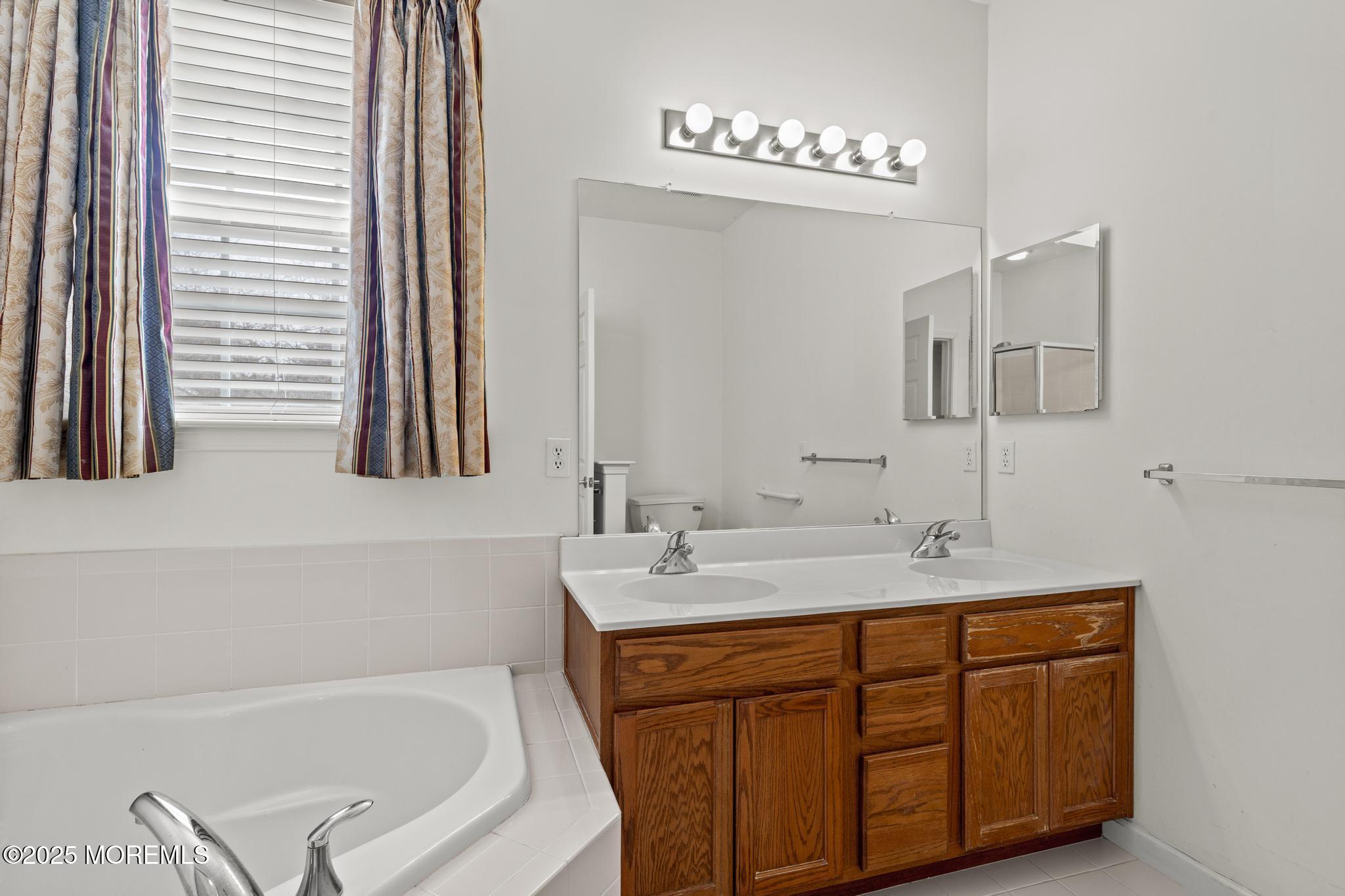 24 Battle Road Manchester Township, NJ 08759 - Photo 22 of 30 a bathroom with a tub sink and mirror