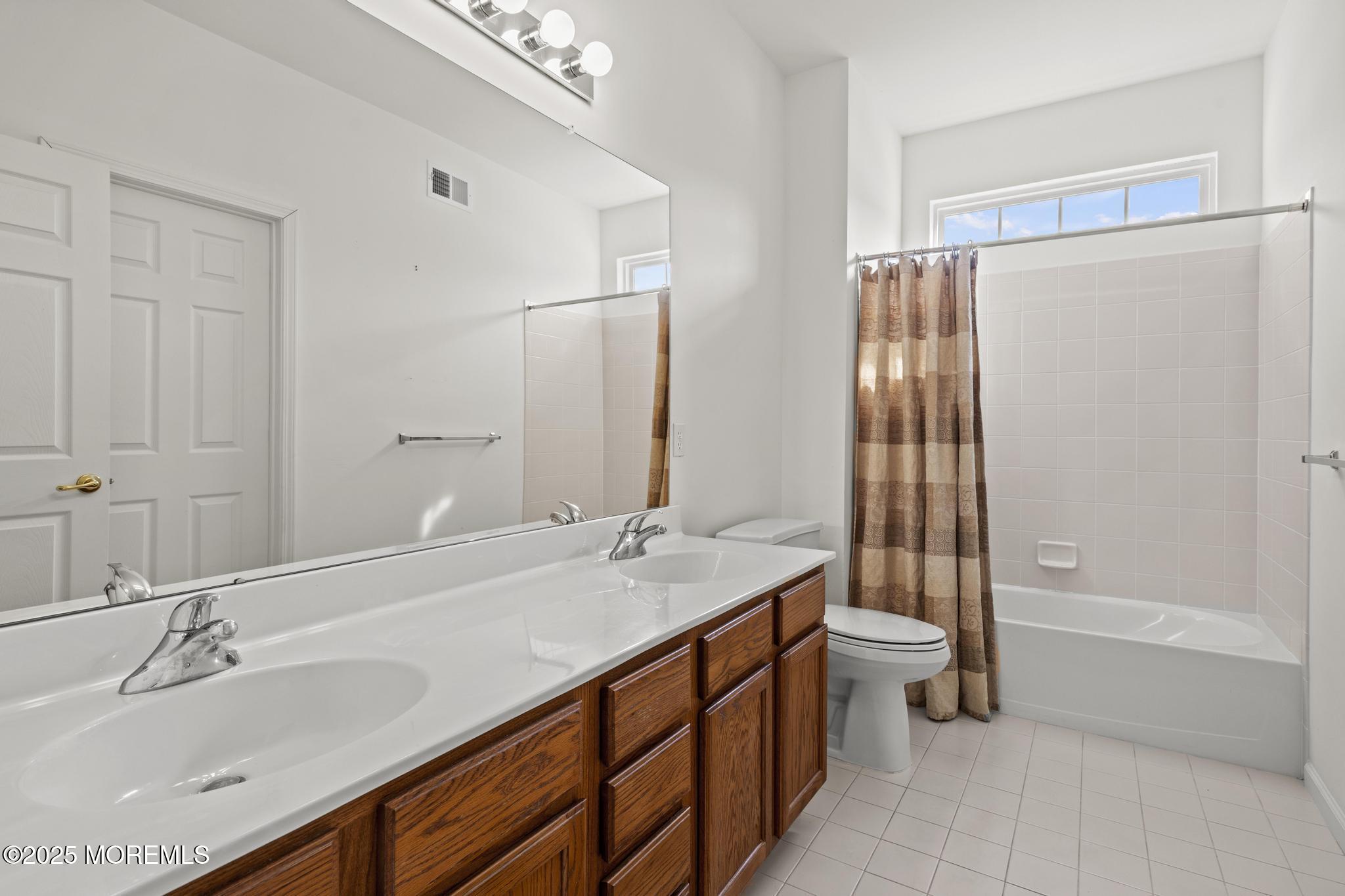 24 Battle Road Manchester Township, NJ 08759 - Photo 27 of 30 a bathroom with a double vanity sink toilet and shower
